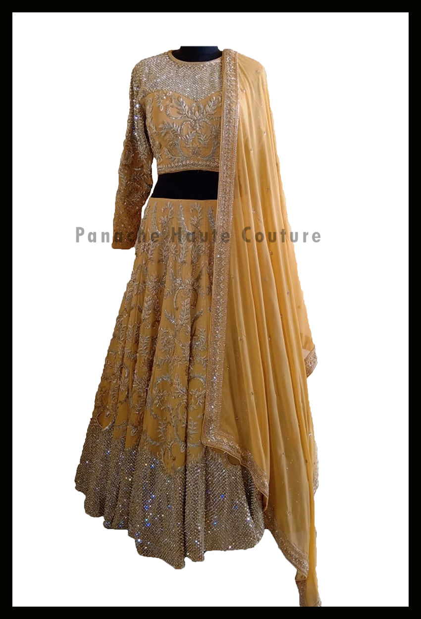 An Elegant Gold Beige Party Wear Lehenga Paired with a Silk Georgette Dupatta From Panache Haute Couture