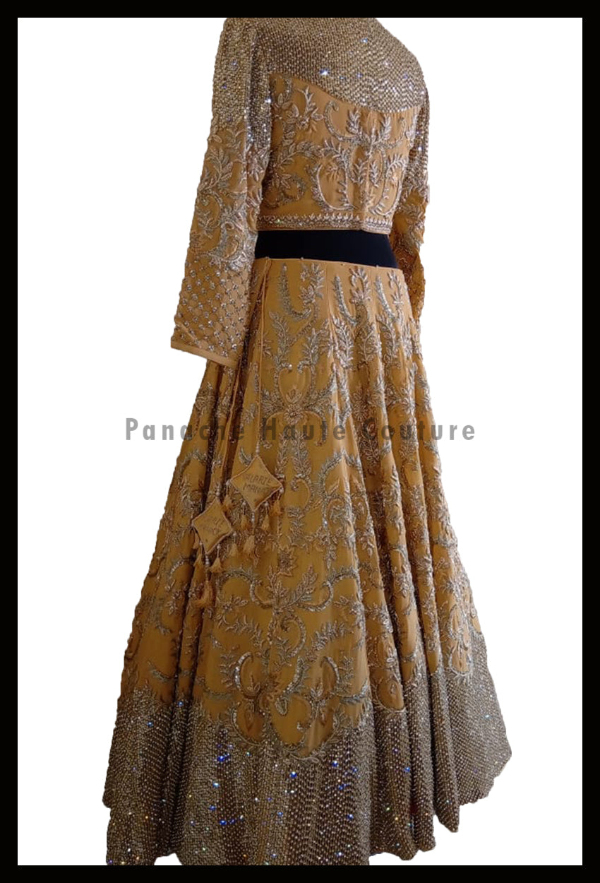 An Elegant Gold Beige Party Wear Lehenga Paired with a Silk Georgette Dupatta From Panache Haute Couture