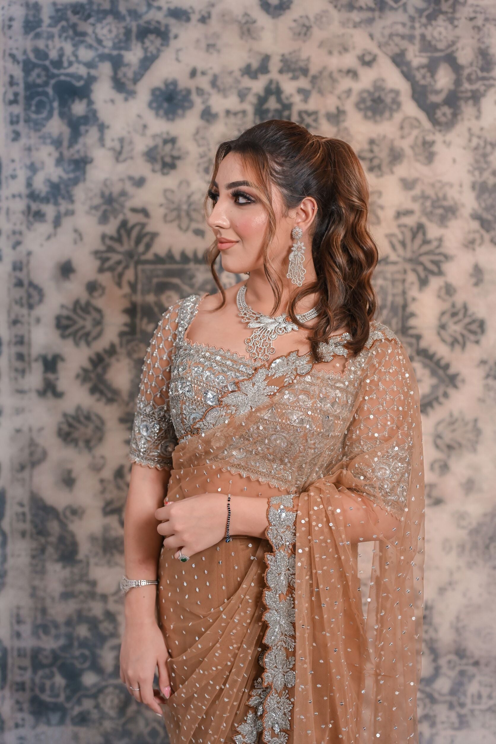 Go for a nonchalant style with this Fawn Brown net saree