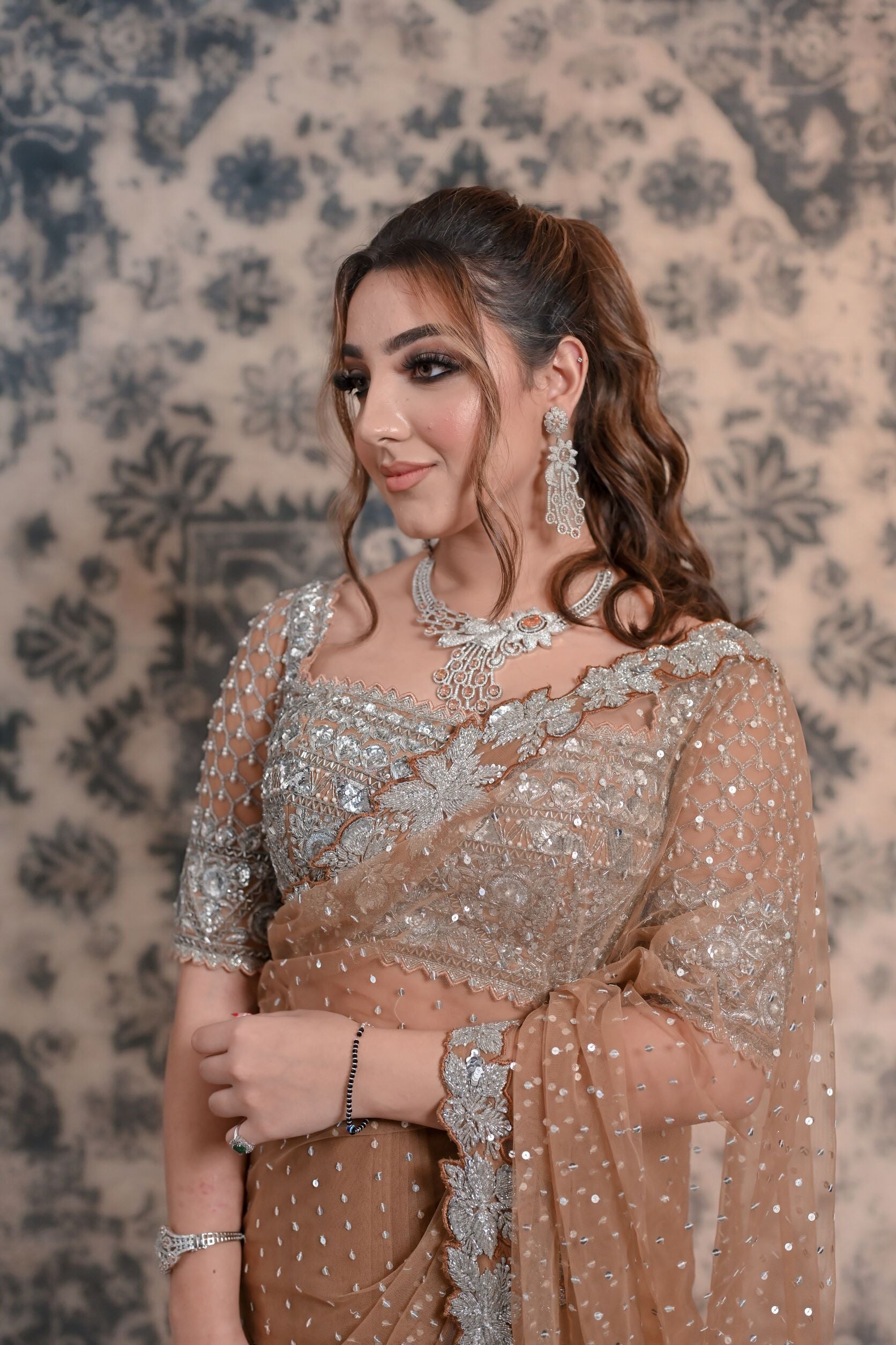 Go for a nonchalant style with this Fawn Brown net saree