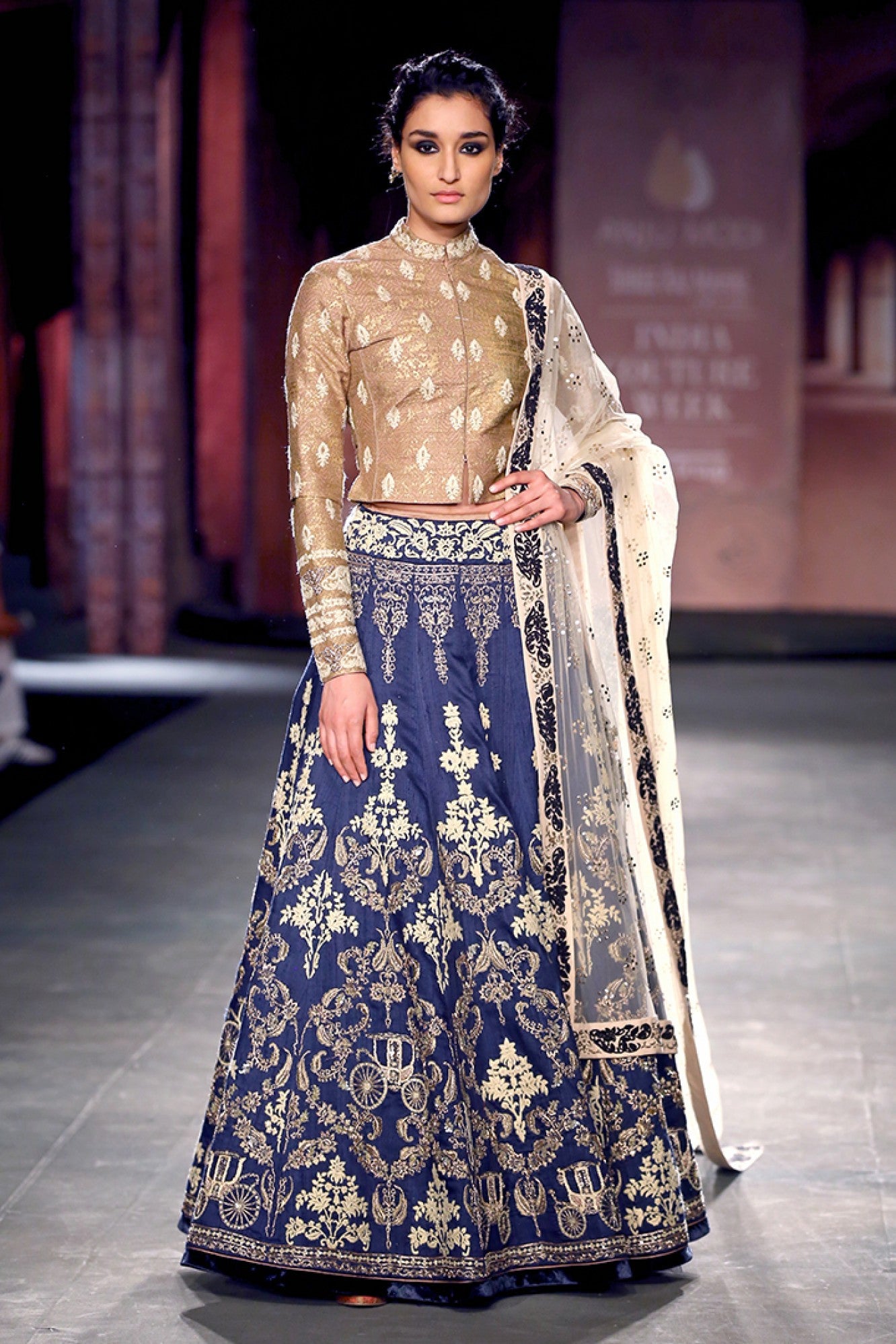 Gold blouse with an embellished indigo lehenga skirt