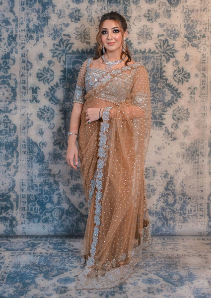 Go for a nonchalant style with this Fawn Brown coloured net saree